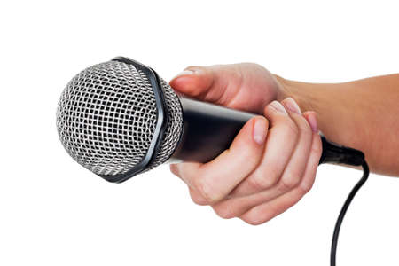 a woman is holding a microphone in hand. interview and opinion pollの写真素材