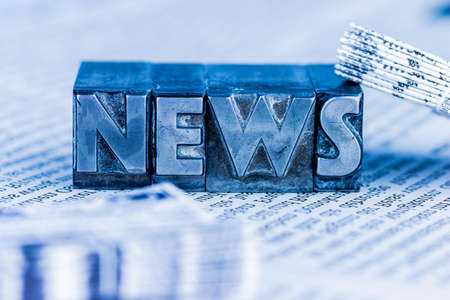 the word news written with lead letters.