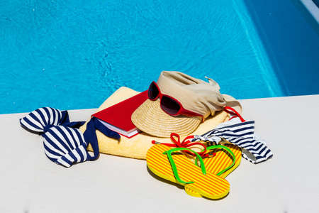 utensils for a nice and relaxing vacation day lying next to a swimming pool. relaxation on holiday.