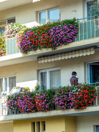 balconies with flowers in a residential building in the city.の写真素材