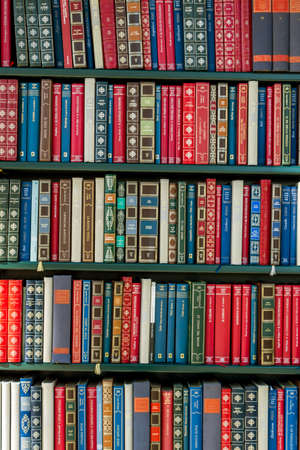many different books in a library. symbol photo for education and science