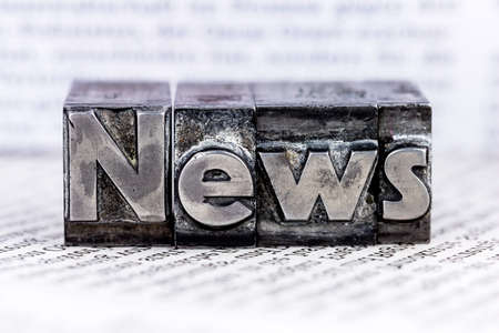 the word news written with lead letters. symbol photo for newsletters, newspapers and informationの写真素材