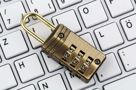 a padlock on a computer keyboard. symbol photo for data security and hacking