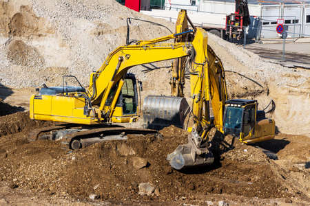 excavator on a construction site. bucket with soil, ground work.の写真素材