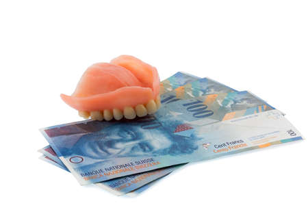 dentition and swiss franc symbol photo for dentures, treatment costs and payment