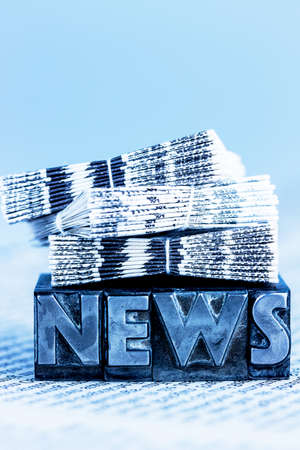 the word news written with lead letters. symbol photo for newsletters, newspapers and informationの写真素材
