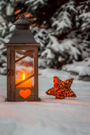 a street lamp glowing in the snow at christmas. romantic light on one evening in the winter. peace and quietの写真素材
