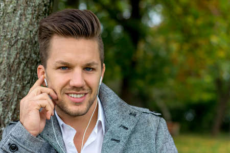 a man listening to music on your mobile phone. talking on the mobile phone.の写真素材