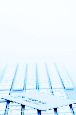 close up of a credit card for cashless payment and keyboard. photo icon for shopping on the...