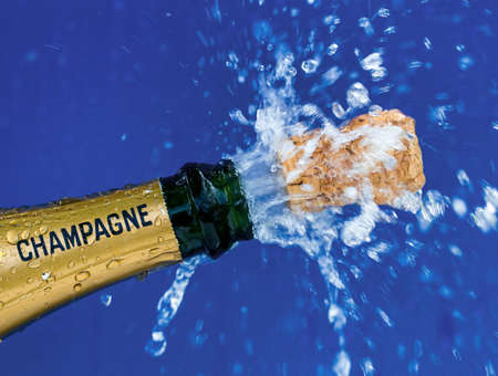 champagne bottle is opened. cork shoots out of the champagne bottle. photo icon for new year, new year, celebrations and openings.の写真素材