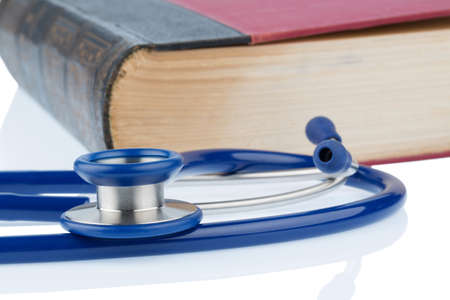 book and stethoscope, symbolic photo for bungling doctors errors and expertiseの写真素材