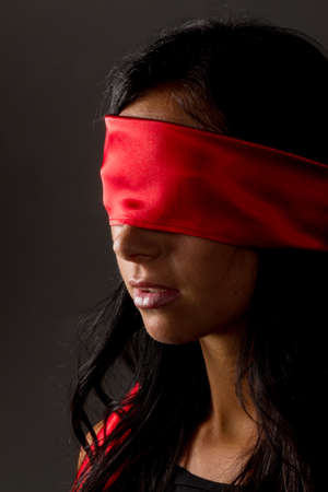 a young woman with fastened eyes.の写真素材