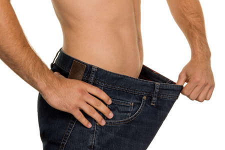 a man has taken off with a successful diet a lot of body weight.の写真素材