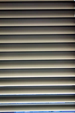 to protect against heat and sun blinds are attached to a window.の写真素材