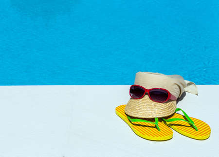 utensils for a nice relaxing vacation day lying next to a swimming pool. relaxation on vacation.の写真素材