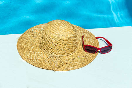 utensils for a nice relaxing vacation day lying next to a swimming pool. relaxation on vacation.の写真素材