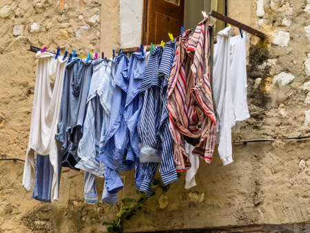washing on the line in front of a windowの写真素材