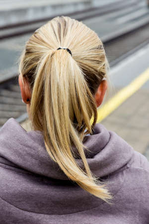 portrait of a thoughtful young woman from behind