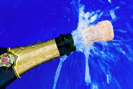 champagne bottle is opened. cork shoots out of the champagne bottle. photo icon for new year, new year, celebrations and openings.の写真素材