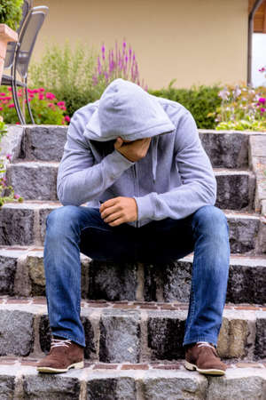 a man sitting alone on stageの写真素材