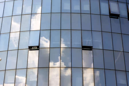 the haas haus in vienna, austria. glass facade with reflection of clouds.,