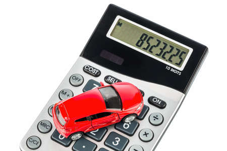 a car is on a calculator. cost of gasoline, wear and insurance. car costs are not paid by commuter tax.の写真素材