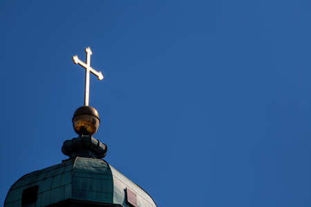 latin cross on a roof, a symbol of christianity, faith, sacrificeの写真素材