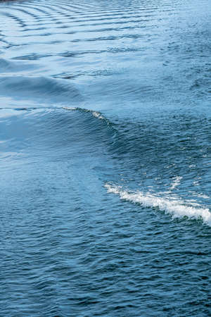 a ship is making waves in the trip across the lakeの写真素材