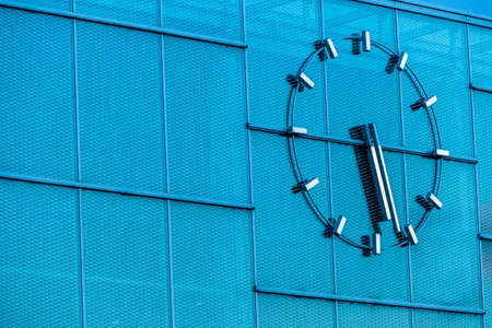 a large clock on a modern buildingの写真素材