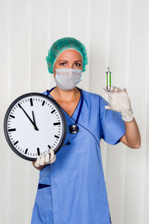 a nurse or doctor in surgical clothing before surgery. symbolic photo for stress and overtime in the hospital.の写真素材