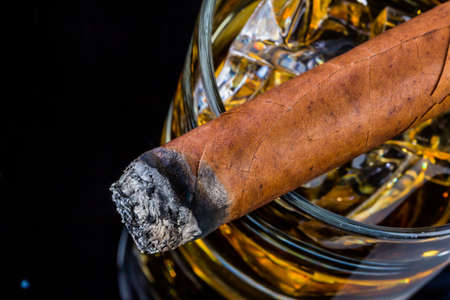 cigar and whiskey. a symbol photo for addiction and relatedの写真素材