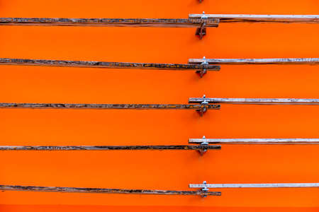 boards in front of an orange wall, symbol of the background and structureの写真素材