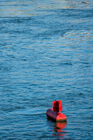 red buoy water surface, symbol of navigation, security, navigationの写真素材