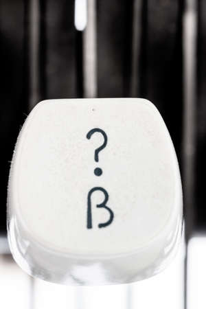 question mark on an antique typewriter. symbolic photo for questions and answersの写真素材