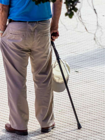 a tourist with a geshtock and a cap as sun protectionの写真素材