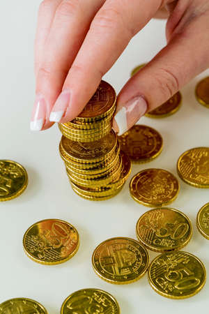 a woman stacking coins. save money for the future.