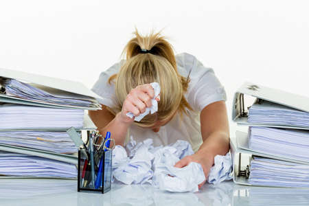 young woman in office is overwhelmed with work. burnout at work or study.の写真素材