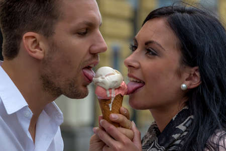 a young couple with a bag of ice. ice cream cones as refreshment in summerの写真素材