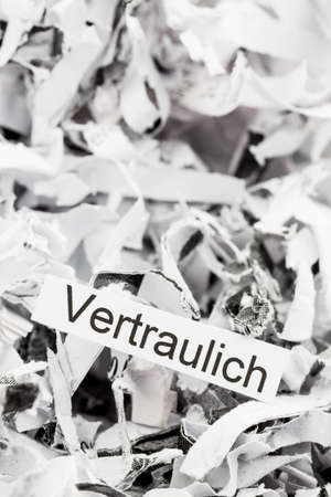 papierschnitzel tagged confidential, symbol photo for data destruction and confidentialityの写真素材