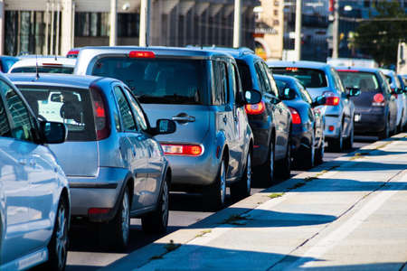 in rush hour traffic jam cars on a street in downtown. problems in city traffic