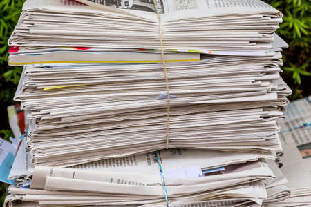 a stack of old newspapers ready for removal by waste paper disposalの写真素材