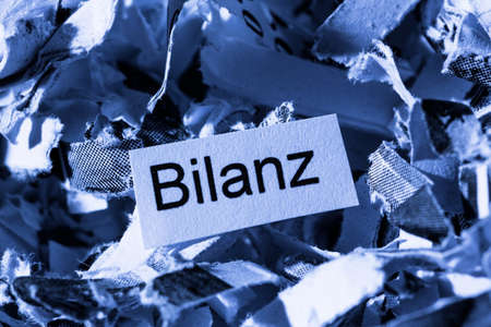 papierschnitzel keyword balance, symbol photo for data destruction, accounting, and economic analysisの写真素材