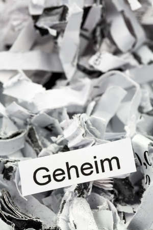 papierschnitzel tagged with secret, symbol photo for data destruction, confidentiality and industrial espionageの写真素材