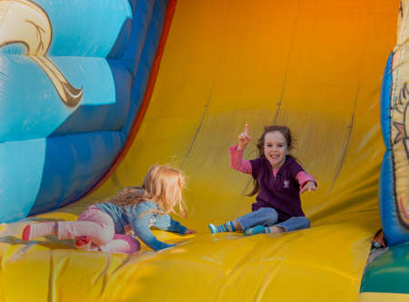 at a folk festival children have a lot of fun in a bouncy castle.の写真素材
