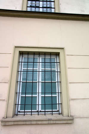 barred windows in a building. symbol image for detention, imprisonment and crime