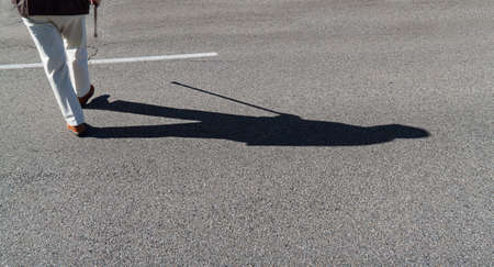 hand of an elderly man with a walking cane. senior with disabilitiesの写真素材
