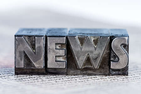 the word news written with lead letters. photo icon for newsletters, newspapers and informationの写真素材