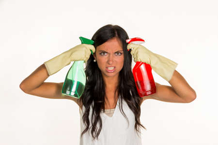a young woman is annoyed that she has to make the house cleaning.の写真素材