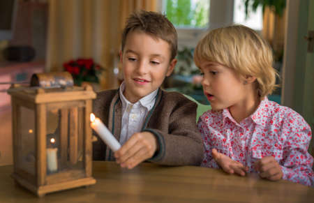 two children with a lantern and a candle. symbol photo for advent and christmasの写真素材