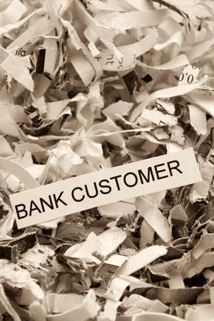 papierschnitzel tagged bank customer, symbol photo for data destruction, customer data and banking secrecyの写真素材